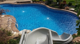 Fun-ride-slide-Dardenne-Prairie-deck-jet-water-feature-stamp-concrete-2-tone-concrete-pool-coping