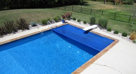 Auto cover blue stamped concrete coping broom finish concrete deck aluminum fence