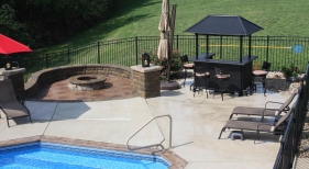 Step-down-conversation-area-off-pool-pillar-bar-paver-natural-firepit-fireplace-Fenton