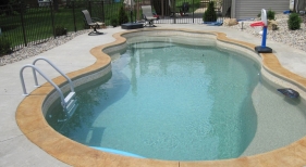 Fiberglass-Viking-freeform-pebble-beach-color-stamped-concrete-coping-kids-heaven