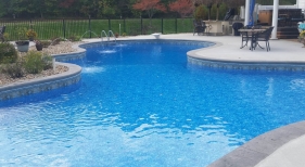 Freeform-large-water-feature-deck-jet-aluminum-fence-washed-tumbled-stone-landscaping
